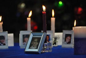A picture of Judy Ogden and a candle sits in front of 14 other candles and pictures of the women killed at L’Ecole Polytechnique in Montreal in 1989. Odgen was murdered by her husband Dale Ogden in Port au Port in 1997.