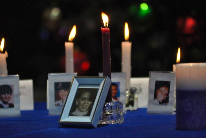A picture of Judy Ogden and a candle sits in front of 14 other candles and pictures of the women killed at L’Ecole Polytechnique in Montreal in 1989. Odgen was murdered by her husband Dale Ogden in Port au Port in 1997.