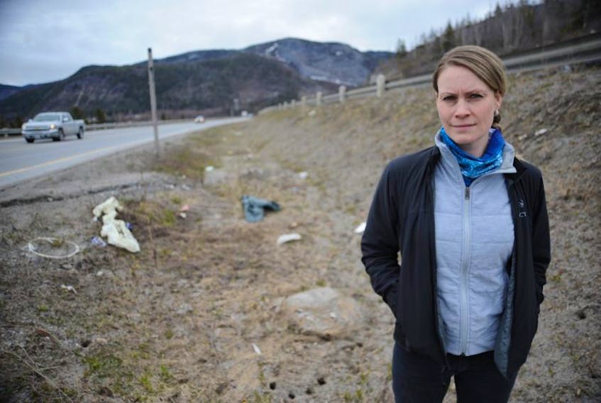 Rebecca Pike of Steady Brook stands near some of the trash she wants to see cleaned up from the Trans-Canada Highway between her hometown and Corner Brook.
