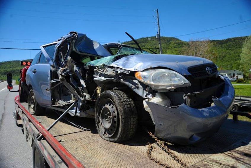The woman driver of this Toyota Matrix, the lone occupant, suffered what police described as minor injuries after the car collided with a cement block and highway signage pole in the Marble Mountain area of the Trans-Canada Highway near Steady Brook Monday afternoon.