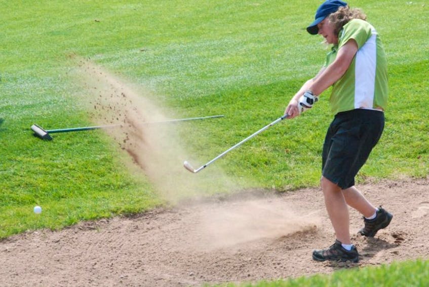 Kathleen Jean, a member of Harmon Seaside Links in Stephenville, uses an iron to get out of the bunker on No. 1 during the first round of the Canadian women’s mid-amateur and seniors golf championship Tuesday afternoon at Humber Valley Resort golf course.