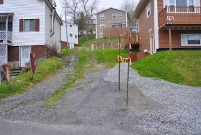 ['Joe Bennett has removed the fence that had prevented access to the lane formerly known as Bond Street on the west side of Corner Brook. Bennett said he took down the fence to avoid being fined by the city.']