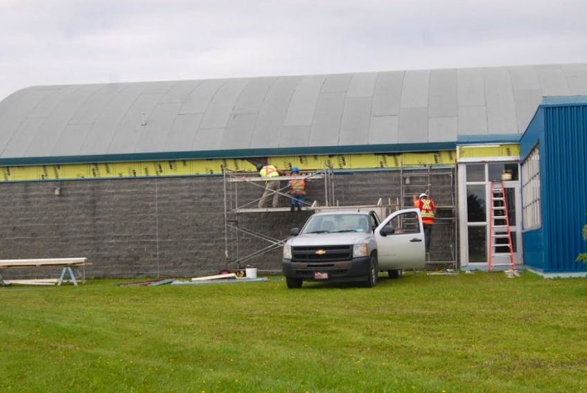 A recladding of the exterior siding on the Regional Aquatic Centre in Stephenville is ongoing by workers with Tech Construction out of Corner Brook, seen here replacing some of the steel siding.