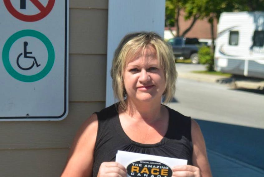 Manager Debbie Davis stands outside Centre Bowl with a letter confirming the alley as an official location on The Amazing Race Canada. The alley is a family business owned and operated by Debbie and husband Gord Davis.