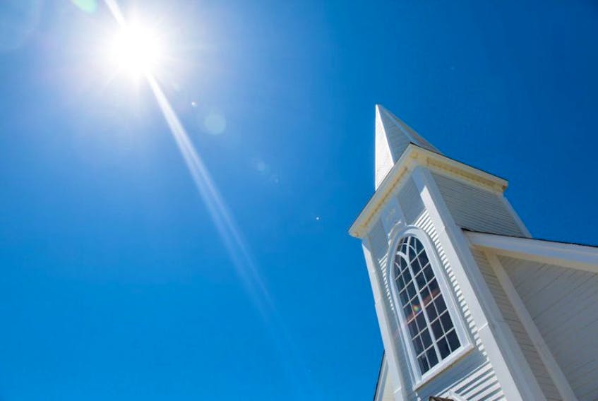 The newly renovated St. Pat’s church steeple in Woody Point gleaming in the early summer sunlight.