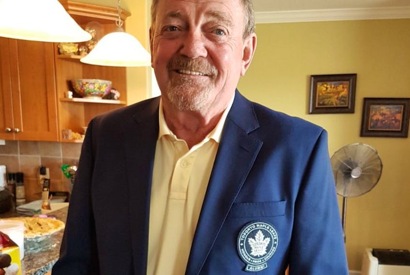 Former National Hockey League player Joe Lundrigan Jr. poses for a photo with his Toronto Maple Leafs alumni blazer on.