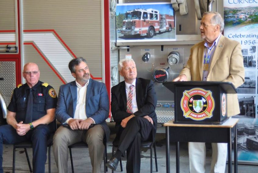 Coun. Keith Cormier speaks during an event announcing funding for a new fire truck for the Corner Brook Fire Department at the fire station on Friday. Seated, from left, are deputy fire chief Craig Harnum, Todd Flynn, the city’s director of protective services, and Municipal Affairs Minister Eddie Joyce.