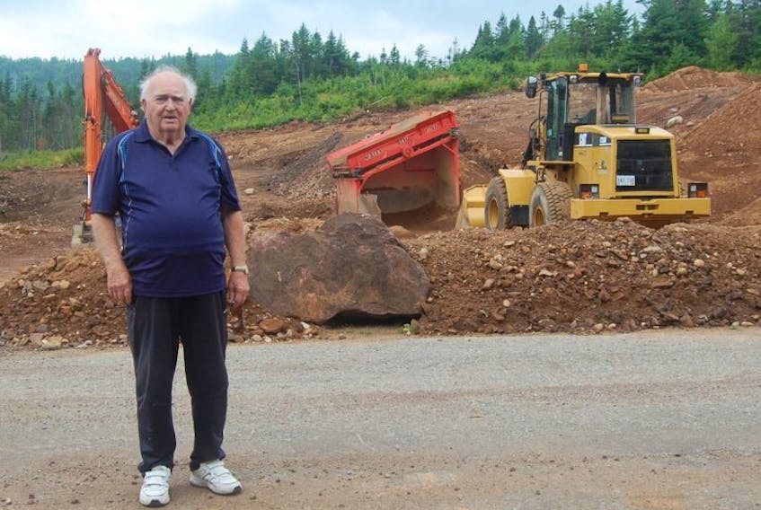 Cliff Goodyear, who is heading up a committee concerned about a rock quarry on Seal Cove Road in Stephenville Crossing, is seen standing in front of the quarry being operated by Curnew’s Construction.