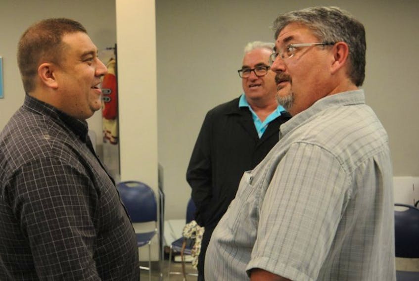 Corner Brook’s mayor-elect Jim Parsons, left, chats with Lenny Benoit, who fell just 39 votes shy of being elected to city council in Tuesday’s election. Looking on is Bill Griffin, who earned the most votes for city councillor.