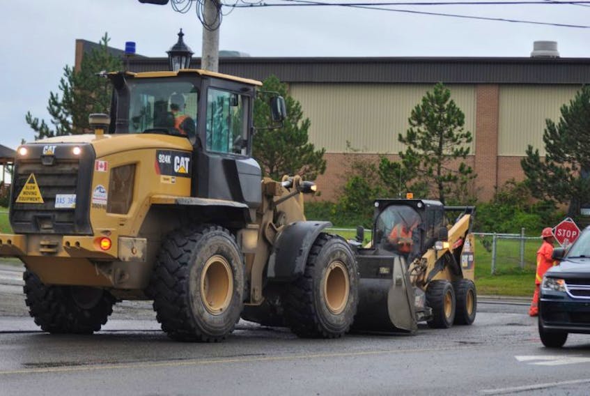 Equipment owned by Marine Contractors Inc. are see sweeping up the residue from a milling process on a section of Main Street in Stephenville where pavement laid last November is being replaced.