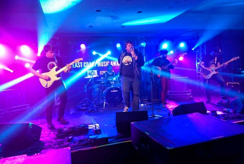 Members of Waterfront Fire, including: (back) Ryan Tobin, drums; from left (front) Ben Thistle, guitar; Jordan Coaker, vocals; Andrew Boyd, guitar; and Cody O’Quinn, guitar; are seen playing at the East Coast Music Awards.
