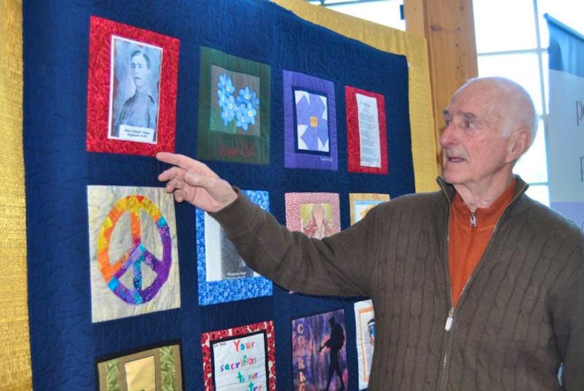 Bill Hogan stands near the quilt featuring a picture of his father, Aiden Hogan, that is part of the “Peace by Piece: Quilted Memories of Newfoundland in the Great War” exhibition currently on display in Corner Brook. The exhibition opening was held at city hall on Thursday afternoon.