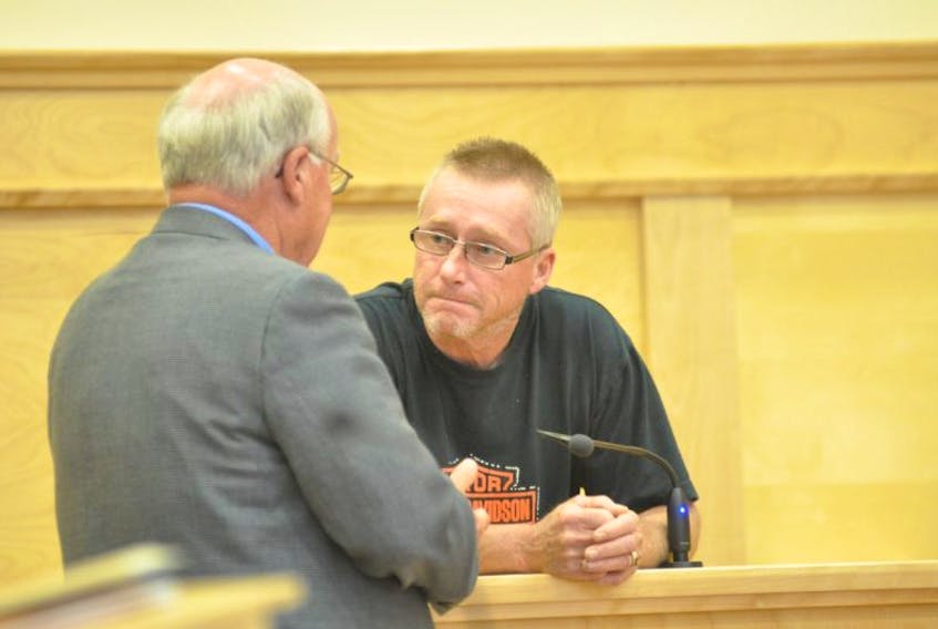 Terrance Blanchard is seen talking with his lawyer Bob Matthews in provincial court in Corner Brook on Monday.