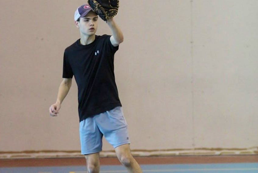 Colin Hulan has a toss during a Canada Summer Games baseball workout at the Corner Brook Civic Centre Annex.