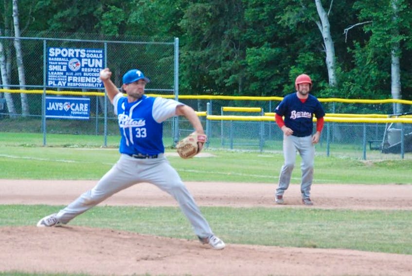Steve Hynes takes a lead from first place as Gander Pilots ace A. J. Whiffen gets ready to throw to home plate during the provincial senior B baseball final Sunday at Jubilee Field in Corner Brook.