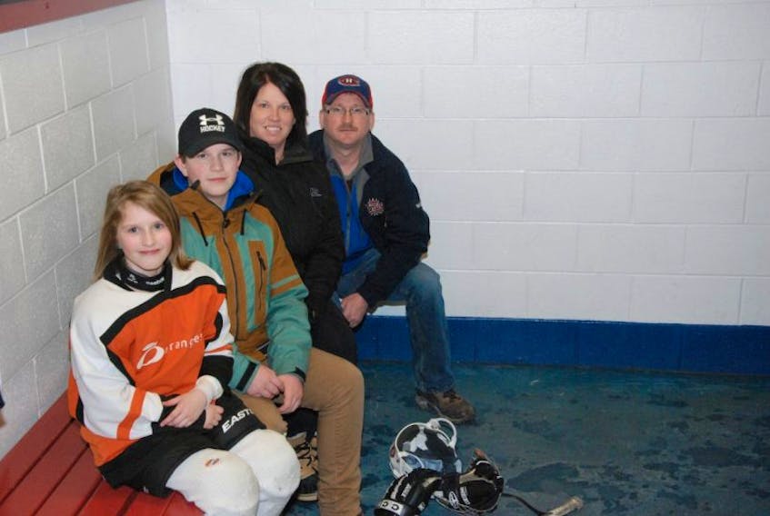 Hockey is a family affair for the Biggin family. Kathryn and Nathan pose with mom and dad at the Kinsmen Arena II before Kathryn hit the ice for a female hockey practice Wednesday.