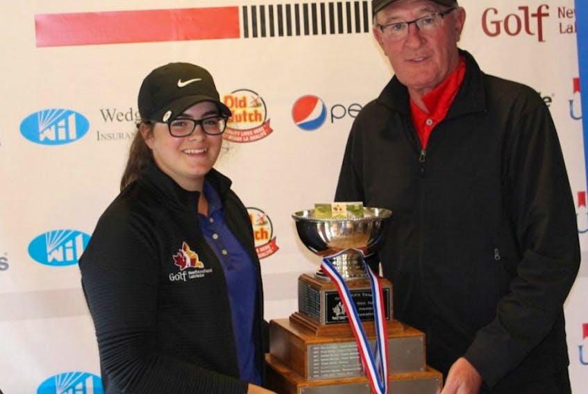 Taylor Cormier, left, poses with the trophy for winning the girls provincial junior golf championship with Jim Sloan, rules director at Golf NL.