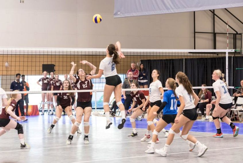 Hailey Oke of Team Newfoundland and Labrador (No. 27) tries to defend against Team Alberta during a female volleyball match at the 2017 Canada Summer Games in Winnipeg.