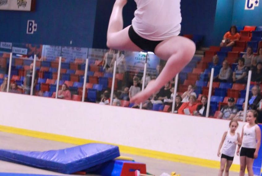 Competitive gymnastic Bethany Stuckless, winner of the club’s leadership award, jumps for the sky.
