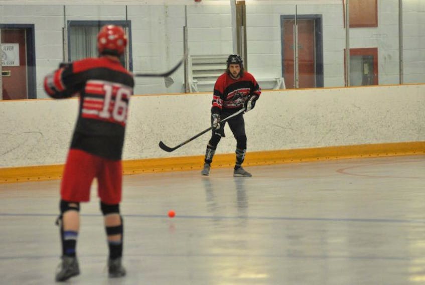Marine Lounge Rebels’ Brian Park (front) passes the ball to Adam O’Brien in action against Port aux Basques at the Newfoundland and Labrador Ball Hockey Association provincial championships at the Kinsmen Arena II in Corner Brook on Saturday.