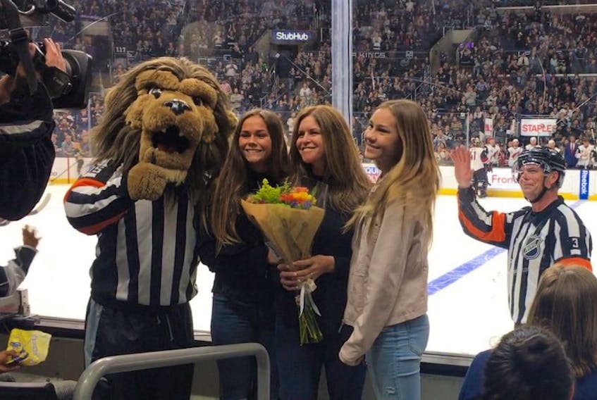 Mike Leggo had his wife and two daughters on hand for his retirement from the National Hockey League after 21 years of wearing the stripes. His family is all smiles for the camera during a pre-game ceremony paying tribute to him as he waves to the crowd with a look of satisfaction on his face.