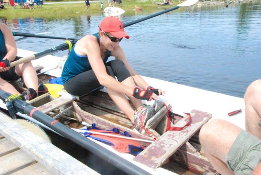 Pasadena’s Robyn Dillman secures her feet in the boat before the bronze-medal race at the 2017 Humber Valley Regatta. Dillman is pleased to see the regatta becoming a community event that people of all ages can enjoy.