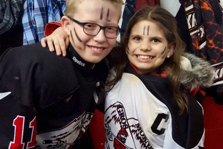 Siblings Carter and Charlie Decker of the Gros Morne Minor Hockey Association pose following a provincial minor hockey tournament at the end of last season.