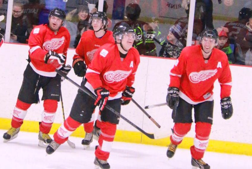 Deer Lake Red Wings’ Malcolm Gale, far left, is shown after scoring his first of three goals against the Corner Brook Royals during the first game of the West Coast Senior Hockey League season on March 4.