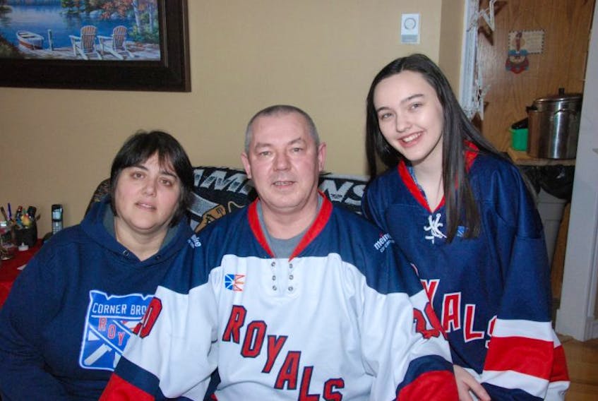 Dave Kearsey/TC Media Corner Brook’s Bernie and Lori Browner pose for a family photo with daughter Marissa, no doubt all decked out in Royals swag, at their Corner Brook home. No senior hockey has left a void in the family so they hope the Corner Brook Royals will return to senior hockey circles in the near future.