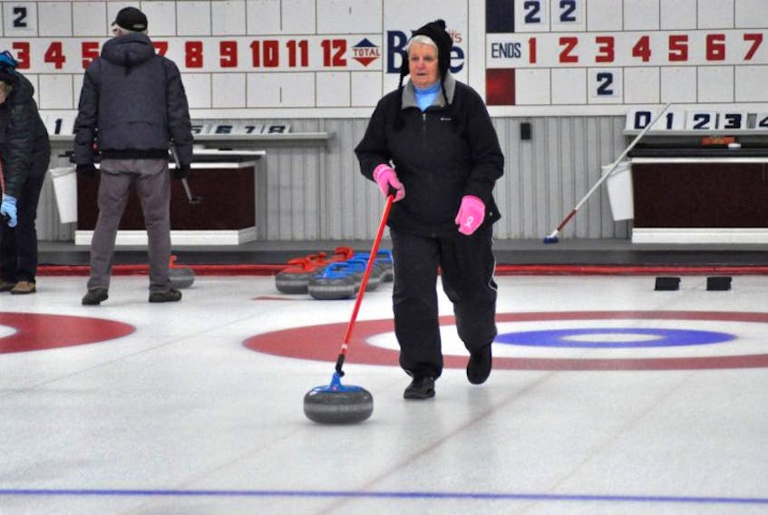 Madelyn Gray of Stephenville, who will soon be 81 years of age, gets ready to release a rock during seniors’ stick curling at the Caribou Curling Club in Stephenville on Friday morning.