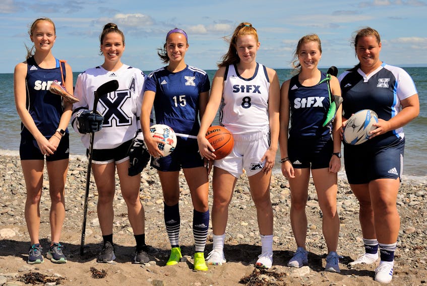 Paige Chisholm (X-Women cross country), Lydia Schurman (X-Women hockey), Paytan Ruiz (X-Women soccer), Kimberly Kingsbury (X-Women basketball), Megan Graham (X-Women track and field) and Sam Lake (X-Women rugby) pose for a pre-season photo. The senior student-athletes were selected by their teams as representatives for each women’s varsity sport for the tradition. Krista McKenna