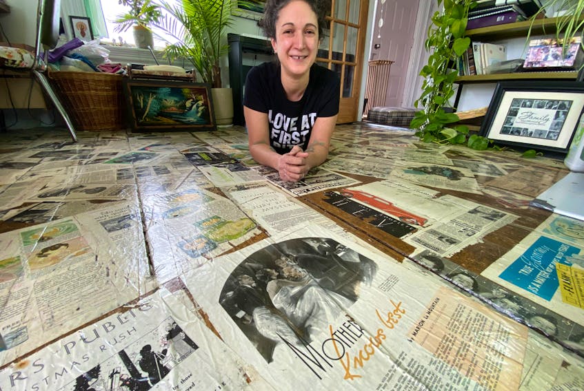 It took six to eight months for Mariah Morningstar to install sheets from mid-1900s newspapers and magazines on her living room floor using polyurethane. 

