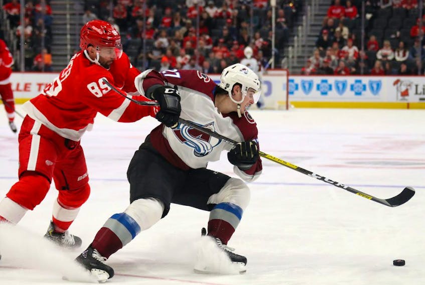 Ryan Graves of the Colorado Avalanche tries to turn away from Sam Gagner of the Detroit Red Wings during a March 2 game at Little Caesars Arena in Detroit. (POSTMEDIA)