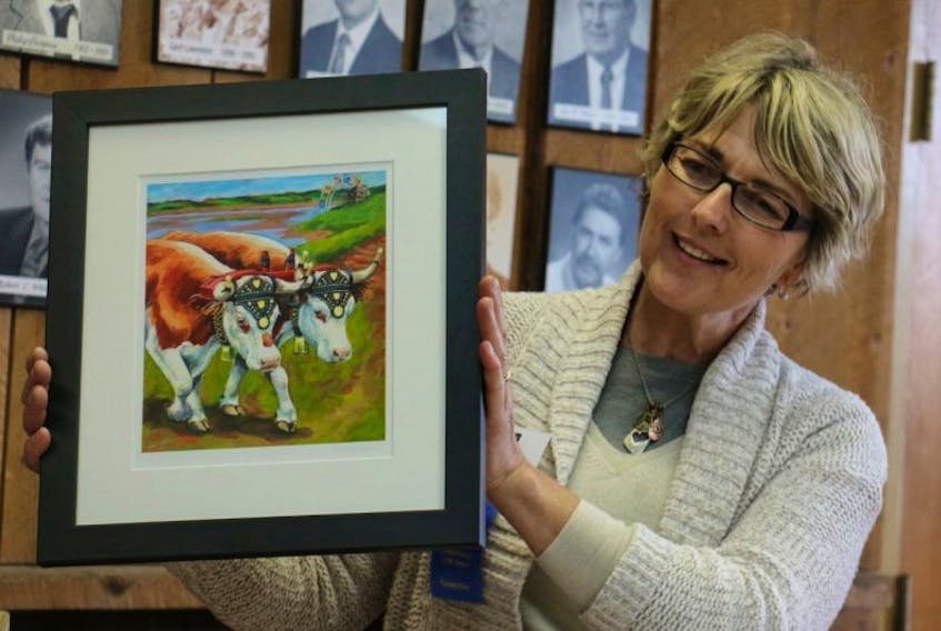 <p>Lisa Hines, one of the main organizers for the year-long celebrations planned to commemorate the 250th anniversary of the Hants County Exhibition, showed off a print of Susan Sweet's painting. Sweet was commissioned to create a memorable piece of art for the historic anniversary and it was unveiled during the Ag Art Festival in May.</p>