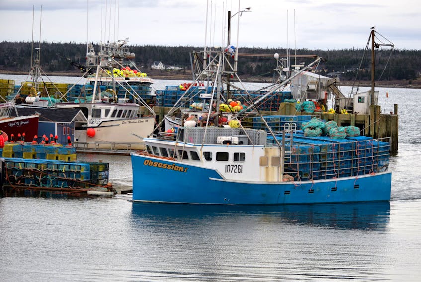 A lobster fishing boat steams back to its berth at the Dennis Point wharf in Lower West Pubnico  with a load of lobster traps aboard to wait for the 2020-2021 season opening in LFA 34. KATHY JOHNSON PHOTO