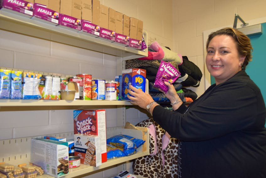 School counsellor at Hillcrest Academy, Shannon Davis, shows some of the donation that have come into the FREE STORE at the school that will help students and families in need.