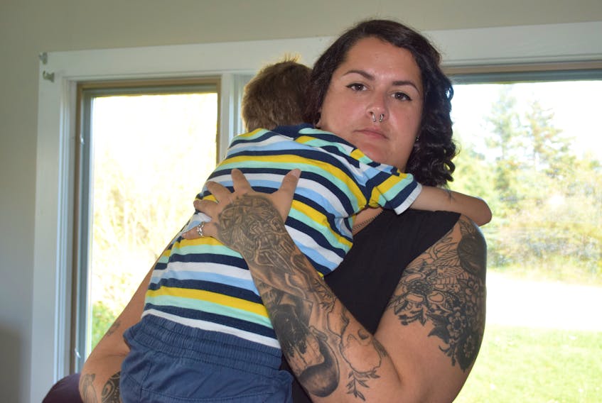 Kayla Atkinson hugs her son Olsson. She is desperately looking for help for Olsson whose complications with autism spectrum disorder have resulted in him not being able to eat enough.