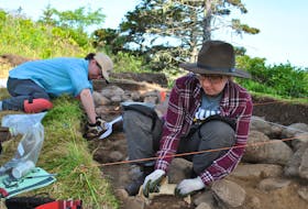Recent university graduates Catherine Lutz (foreground) and Liz Michaels work one of the excavation pits at the Fort St. Louis archaeology dig in Port LaTour. Kathy Johnson photo