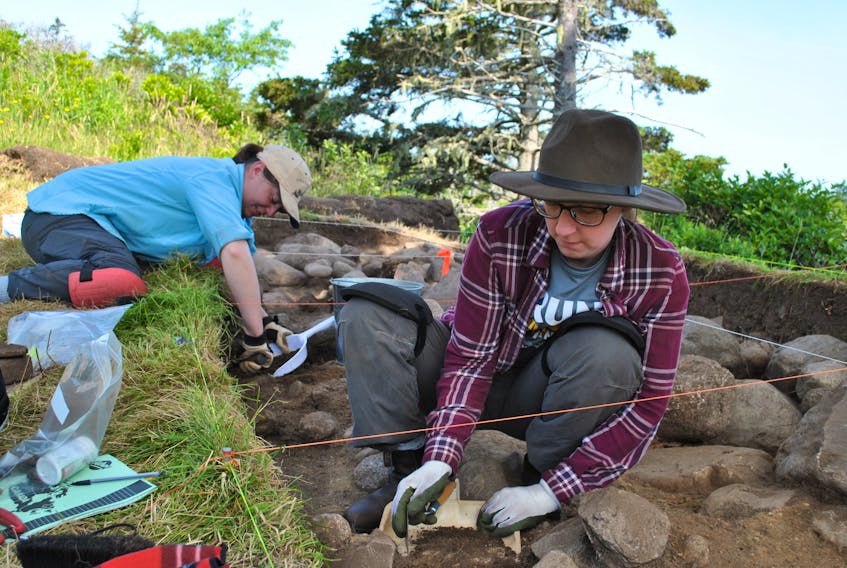 Recent university graduates Catherine Lutz (foreground) and Liz Michaels work one of the excavation pits at the Fort St. Louis archaeology dig in Port LaTour. Kathy Johnson photo
