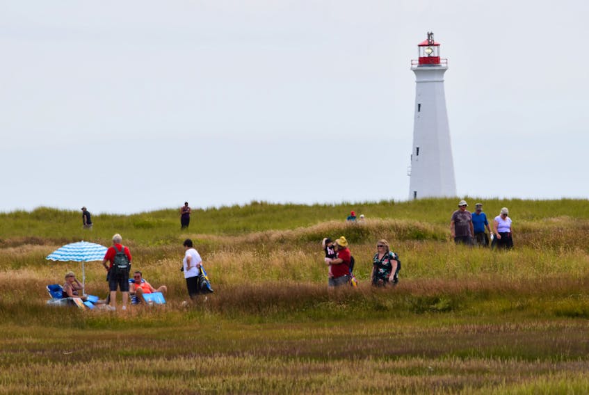 People roam the grassy inland of the Cape Sable Ledge during last year’s Cape Day.