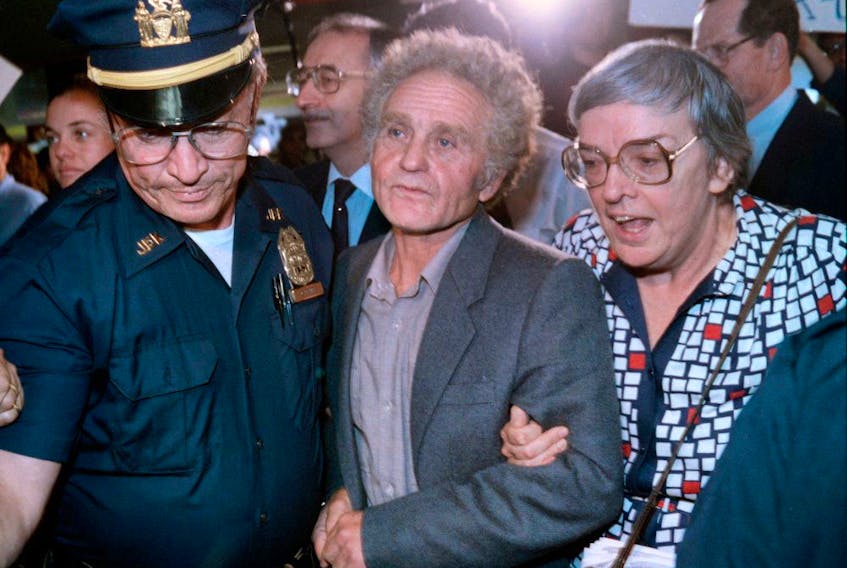 Soviet dissident Yuri Fyodorovich Orlov, centre, arrives in New York after being exiled from the Soviet Union in 1986.