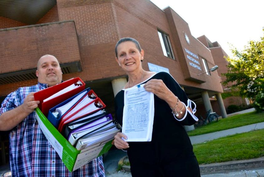 Yarmouth residents Derek Lesser and Sandy Dennis carry a petition containing more than 13,350 signatures into an Aug. 31 meeting with Nova Scotia Health Minister Randy Delorey at the Yarmouth Regional Hospital. The grassroots group Western Nova Scotia Cancer Support Network is pushing for cancer radiation services to be available at the Yarmouth Regional Hospital to serve western Nova Scotia.