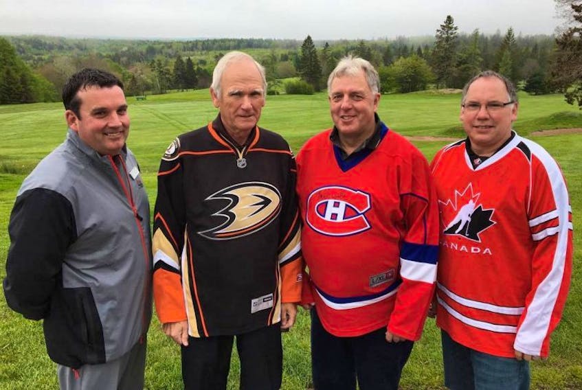 Scott Nickerson, golf pro at the Pines stands in front of the golf course with Digby & Area Health Services Foundation president Phil Barrett and tournament organizers Kevin Ellis and Mike Bartlett, all wearing the jerseys that will be prize items at the tournament.