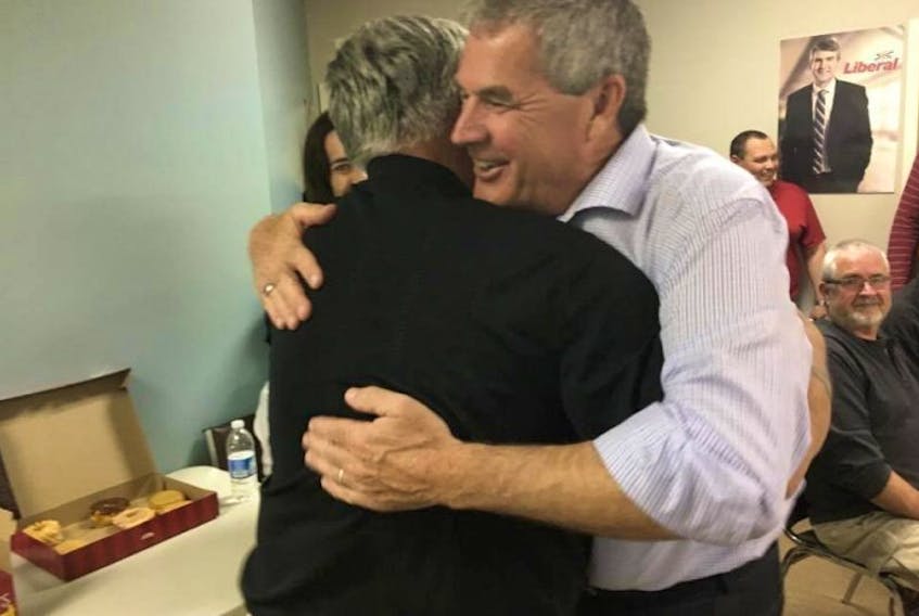 Newly re-elected Gordon Wilson hugs campaign manager Bob Handspiker who he says he "couldn't have gotten the job done without." Wilson said being elected "feels even more special the second time."