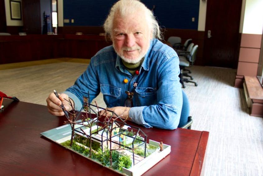 Dan Earle at the Yarmouth town hall with his model of a proposed Maud Lewis memorial park.