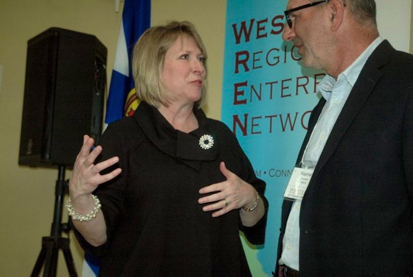 Kelly Regan, Nova Scotia's minister of labour and advanced education, speaks with Warner Comeau, chair of the Western Regional Enterprise Network, Tuesday, March 7, in Meteghan, where the minister announced $100,000 in funding for the Connector Program.
