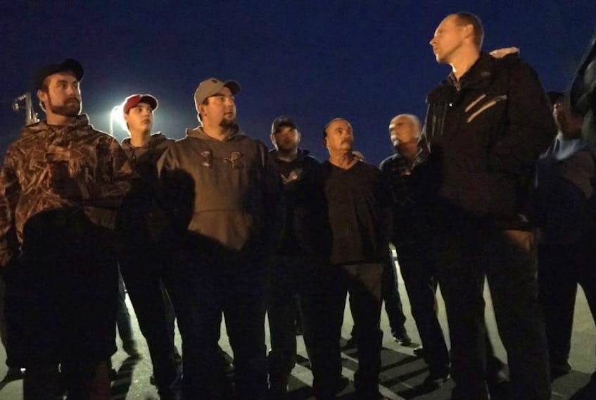 RCMP Sergeant Stephen Power speaks with fishermen at Lobster Rock Wharf in Yarmouth the evening of Sept. 7.