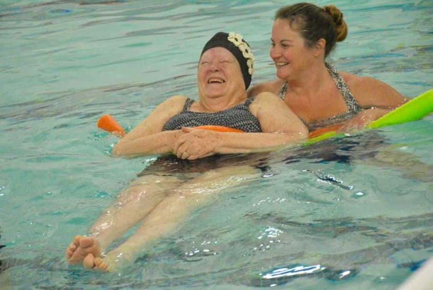 Meadows resident Norma Singer, 87, enjoys some time in the pool at the Yarmouth YMCA, aided by Heather Lowe, occupational therapist at The Meadows. A pool lift is helping seniors like Singer get back into the water.