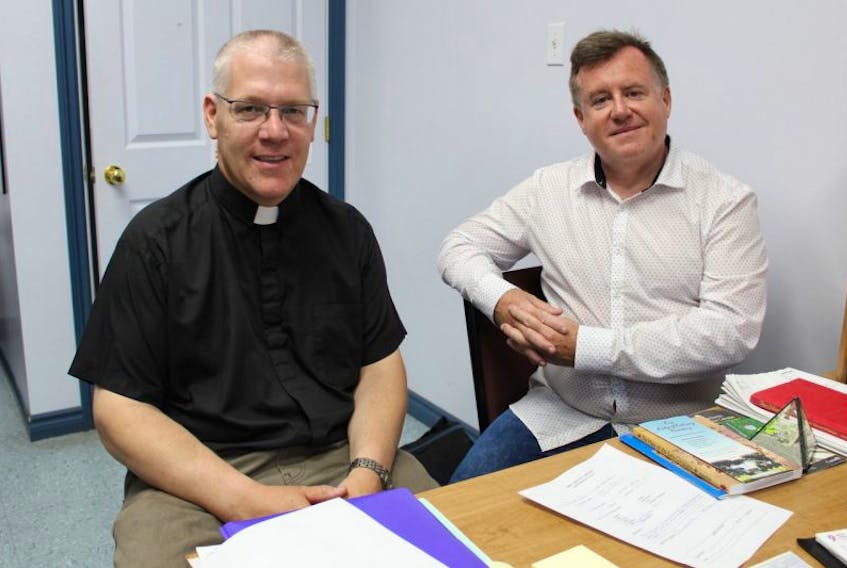 Father Henry Smolenaars and Tony Dorrian are members of the St. Ambrose refugee committee that is trying to bring two Syrian refugee families to Yarmouth.