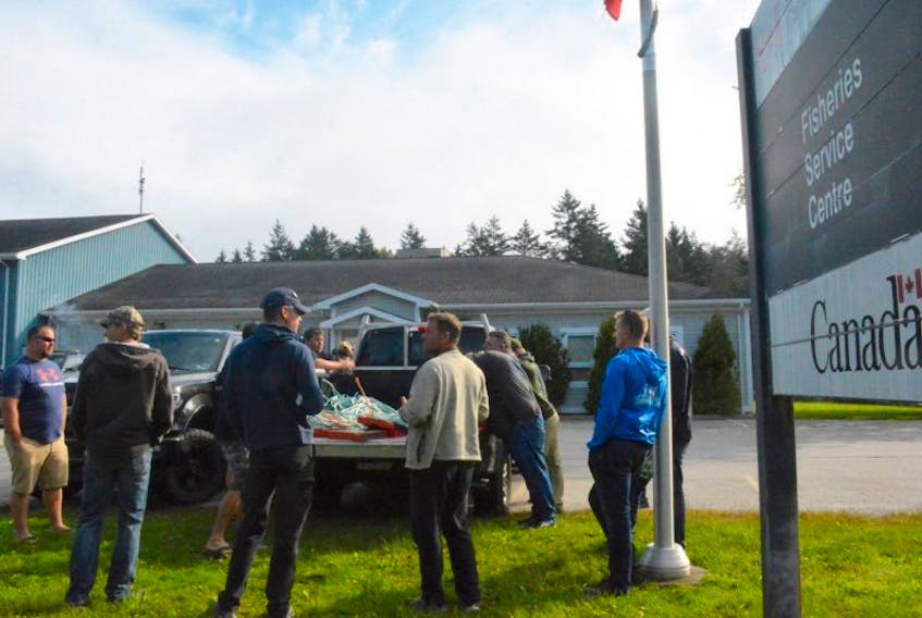 Fishermen gathered in a parking lot at the Department of Fisheries and Oceans detachment in Tusket, Yarmouth County, on Sept. 14. They have expressed concerns that there is illegal commercial fishing happening over the summer and fall months and DFO isn't doing enough to prevent or enforce.